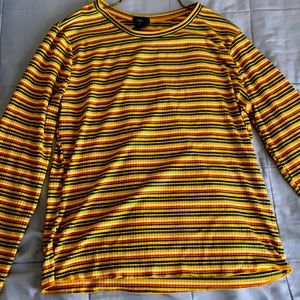 Long sleeve striped shirt with many colors on it.